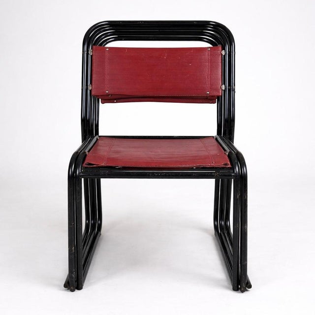A striking set of four 1960s tubular metal dining chairs with original upholstered seats and backs. Constructed from sleek...