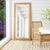 The Butler Specialty Company Flora Full Length Floor Mirror radiates natural charm with its handwoven rattan frame and...