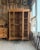 This large art deco oak wardrobe dates from the 1930s. Its three doors, central beveled mirror, and geometric and floral...