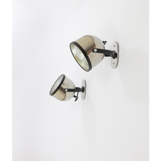 Pair of swiveling spots made of chromed metal designed by Gae Aulenti and Livio Castiglioni for Stilnovo in the 1970s. The...