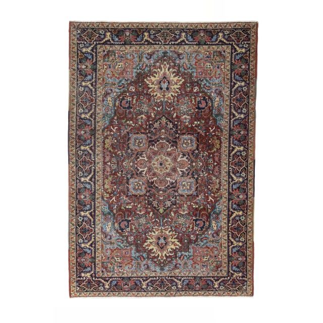This distinctive antique Heriz rug is hand-knotted and impresses with its powerful geometric ornamentation and warm,...