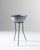 A 20th century enameled bowl on stand from Central Europe, this small antique wash basin elevates upon oxidized metal...