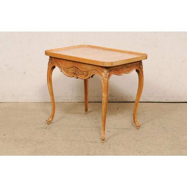 A French carved-wood occasional table with single drawer, from the turn of the 18th and 19th century. This antique side...