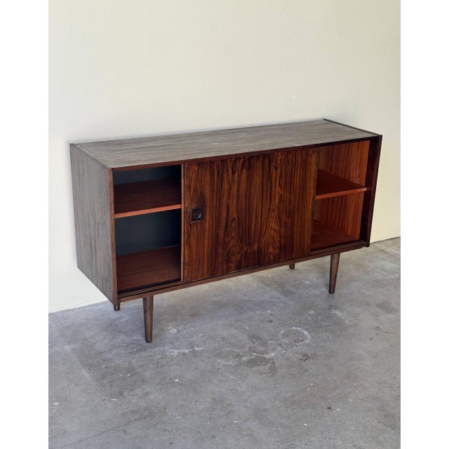 Beautiful vintage Danish mid-century modern sideboard in rich rosewood, dating from the 1960s. This sleek and functional...