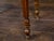A French walnut side table from the 19th century, with tray top, six drawers, carved apron and four fluted legs. Created...
