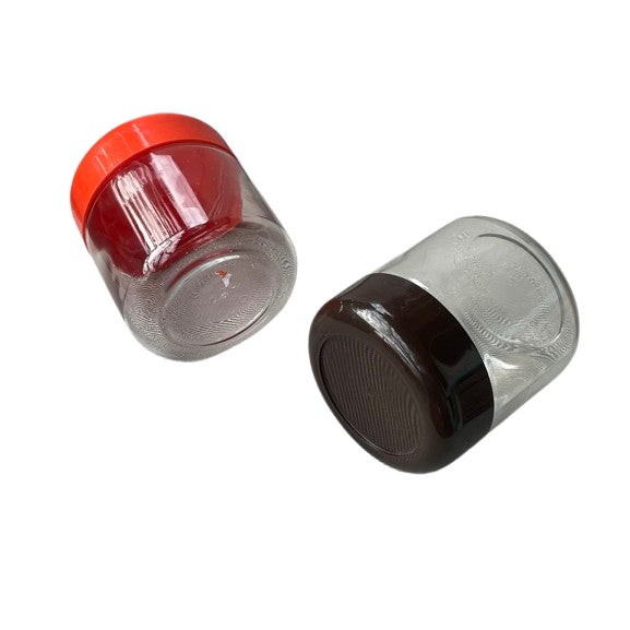 A quintessential example of 1970s American design, this pair of glass storage canisters was produced by the iconic Heller...