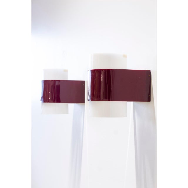 Pair of wall lamps designed by Yki Nummi. Produced in Finland by Orno during the 1950-60s. Made from red and white acrylic...