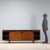 Sideboard with sliding doors, exposed central drawers, and small drawers under the top; walnut veneer. Fair condition,...