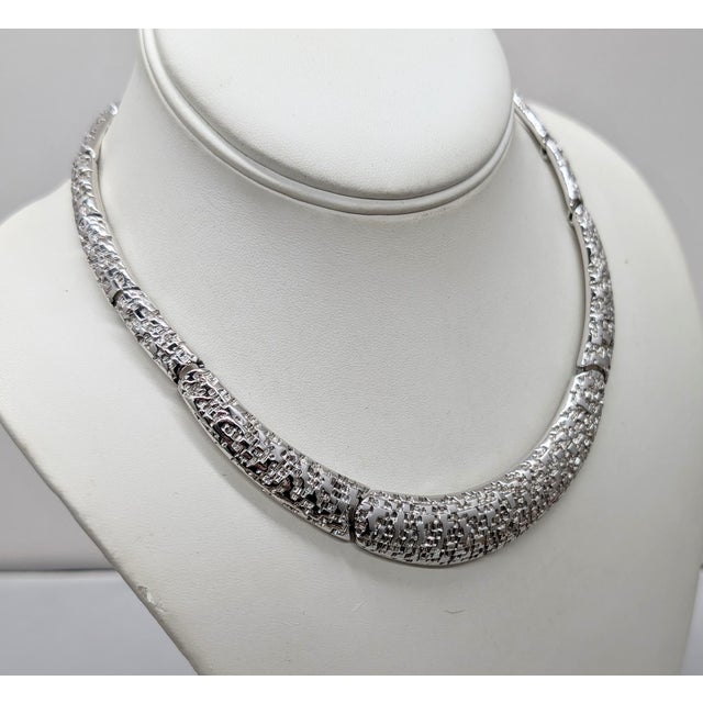 1980s Modernist rhodium plated textured articulated collar necklace with hook clasp. Marked "MONET©" on a hangtag and...