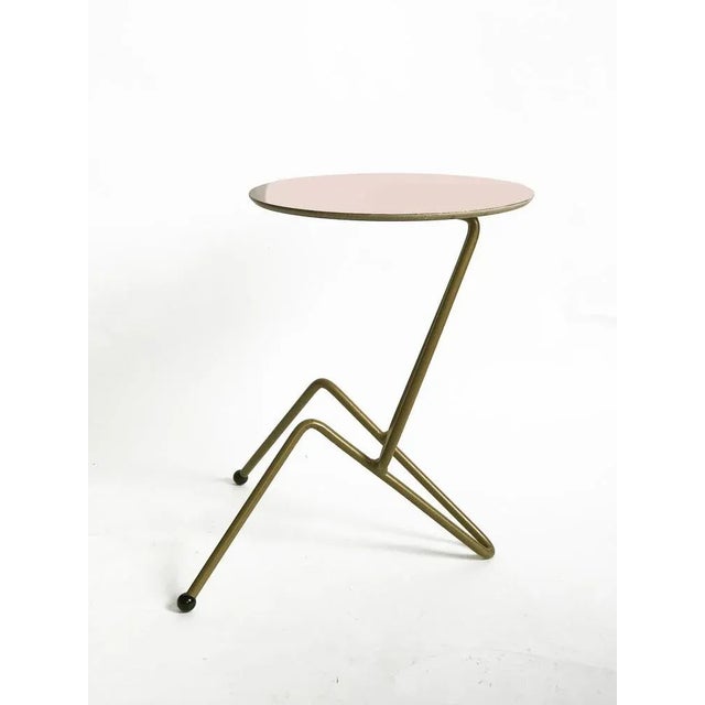 This side table is made of iron tube painted in gold, hand bent and welded . Top is plywood birch, lamitaded with HPL in...