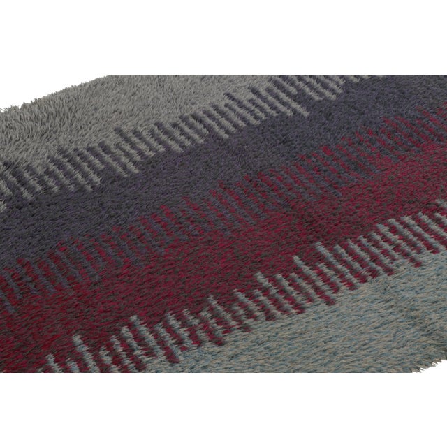 Hand-knotted in lush, high-pile wool in Sweden circa 1960-1970, this 3x6 vintage Swedish Rya runner rug is a bold new...