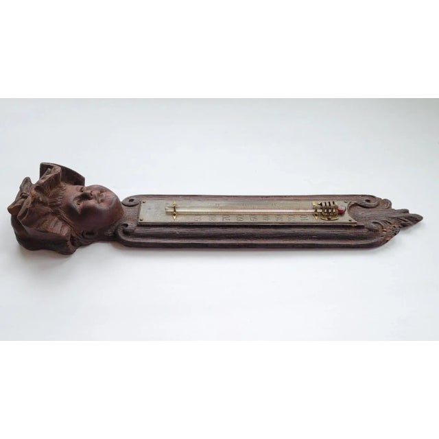 Mid to late 19th c American hand carved wood thermometer with engraved brass temperature plate. Interesting to note is...