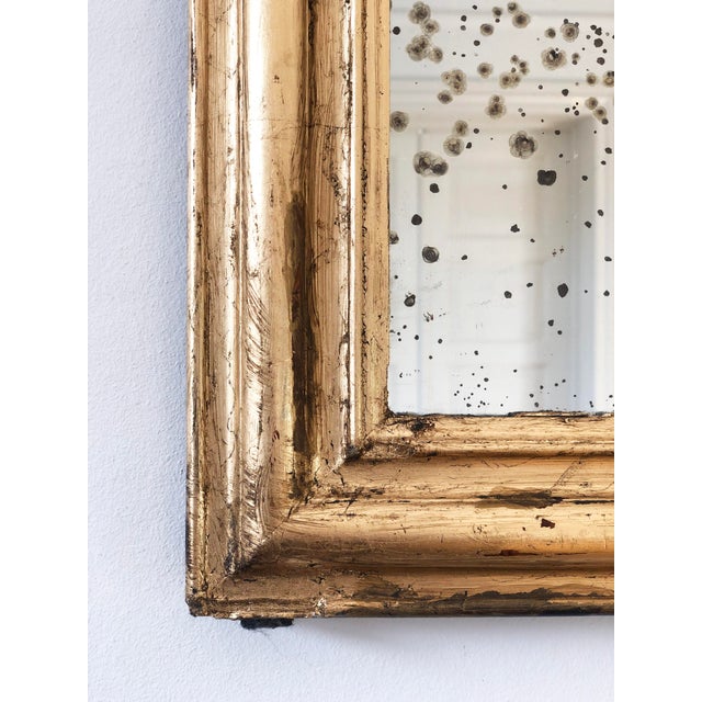 Antique French Louis Philippe mirror, dating to the late 19th century. The mirror features a giltwood frame with a warm,...