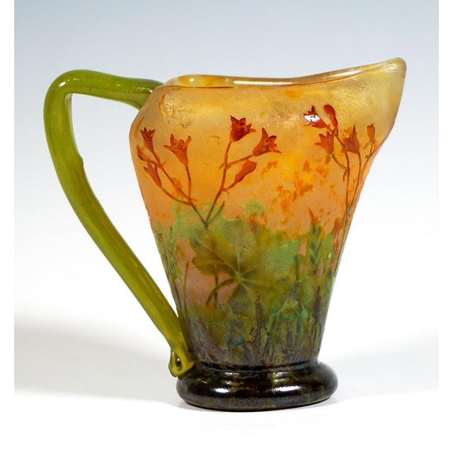Vase with a handle, set on a round, flared base, the body rises conically, widening as it goes up, the upper rim is...