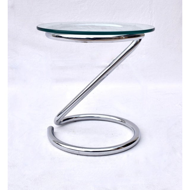 Sculptural Z form Mid-Century Modern chrome and glass end accent table with tubular frame and 1/2" glass top. Eileen Gray...