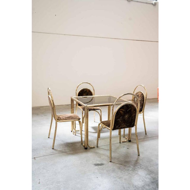 Gold-colored painted iron table and 4 chairs with seat and back in original fabric with floral decorations table: h72 x...