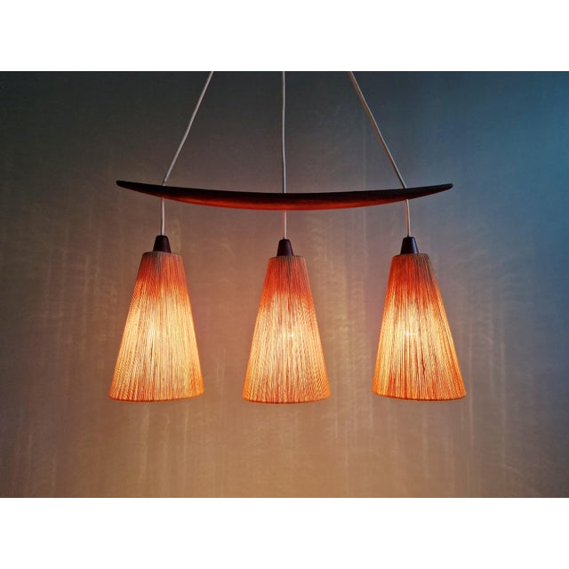 Mid-century teak chandelier with three sisal rope shades, produced by the swiss manufacturer temde in the 1950s-60s....
