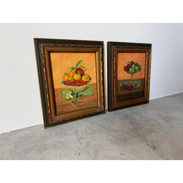 Charming pair of vintage still-life oil paintings on canvas by artist Anne W., dated 1970 and 1973. Each piece depicts a...