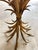 Small gilt metal side table with a wheat sheaf motif. The "Coco Chanel" model, attributed to Robert Gossens. Clear glass...