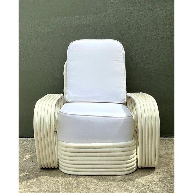 This vintage Paul Frankl six-strand rattan lounge chair is an iconic example of the designer's celebrated mid-century...