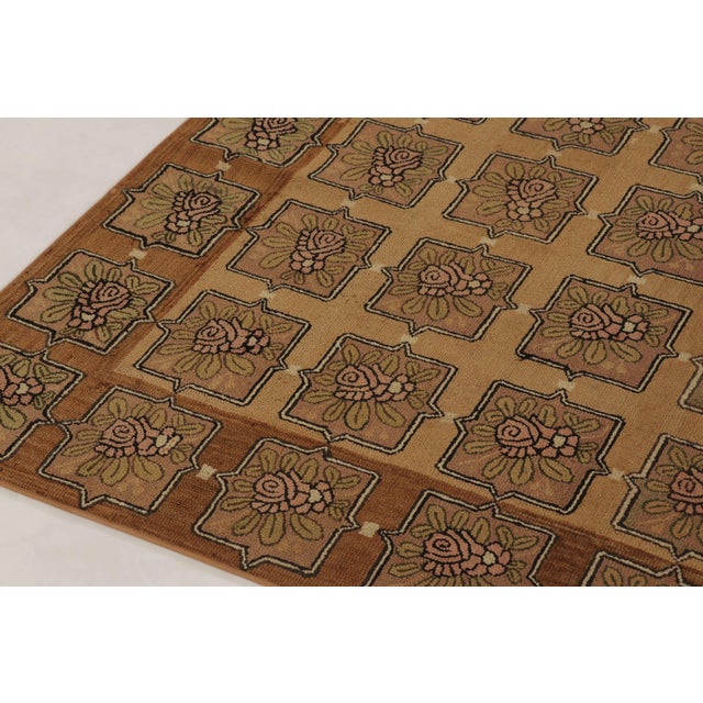 Hand-crafted in wool, this 9x10 antique American hooked rug is a remarkable piece of textile history originating from the...