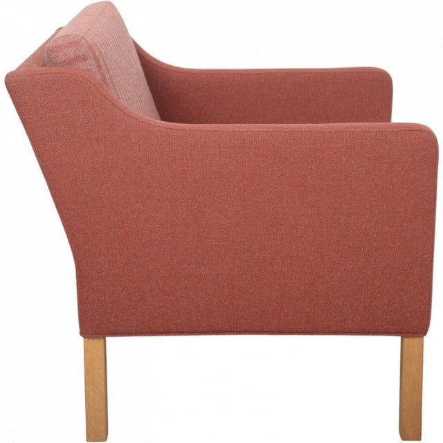 Børge Mogensen 2421 lounge chair upholstered in purple fabric, and with legs of oak. The chair is from the 1980s but was...