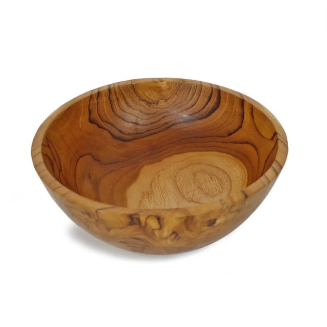 Simple smooth teak wood bowl. Each unique in beautiful natural tones and grain. Each is sold individually.