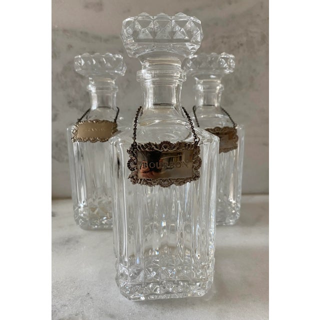 Vintage 1960s cut crystal glass square shaped decanter set with diamond point pattern. Set is unmarked, but most likely by...