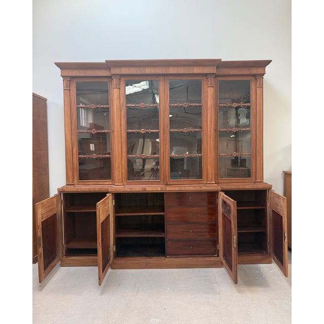 This large english breakfront bookcase, dating from the william iv to early victorian period, commands attention with its...