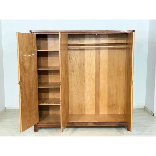 Stylish mid-century wardrobe from the 1960s with beautiful birch veneer. Clean lines, warm wood tones, and generous...