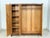 Stylish mid-century wardrobe from the 1960s with beautiful birch veneer. Clean lines, warm wood tones, and generous...