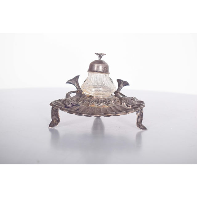 A beautifully crafted marked silver inkwell designed in the shape of a shell, featuring a glass ink tank for a classic...