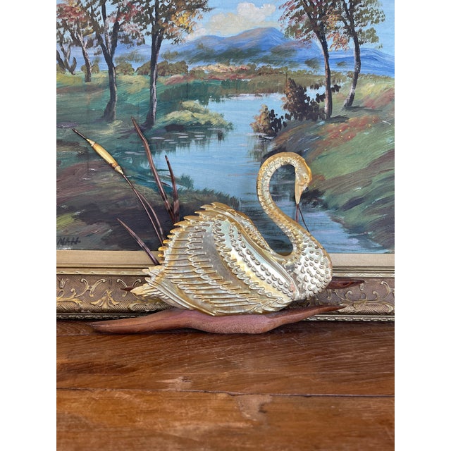 This vintage wall sculpture features a graceful swan with finely detailed wings and neck, accented by hand-formed reeds...