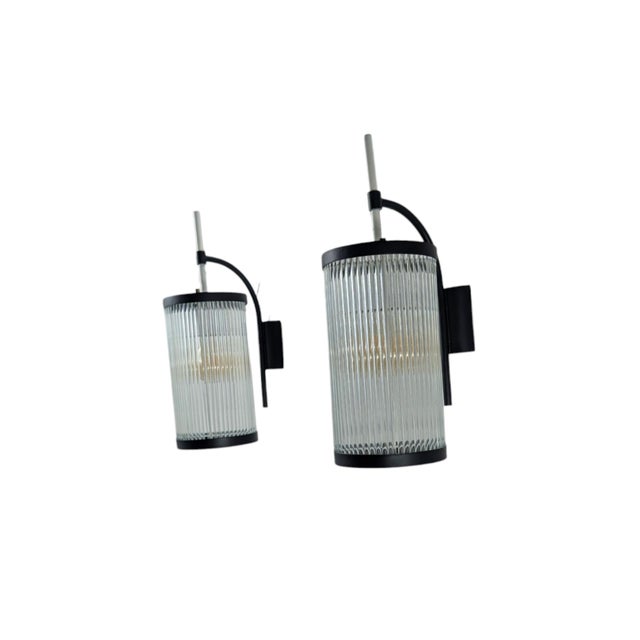 This is a pair of Mid-Century Modern wall lamps, likely dating to the mid-20th century. The piece features a cylindrical...