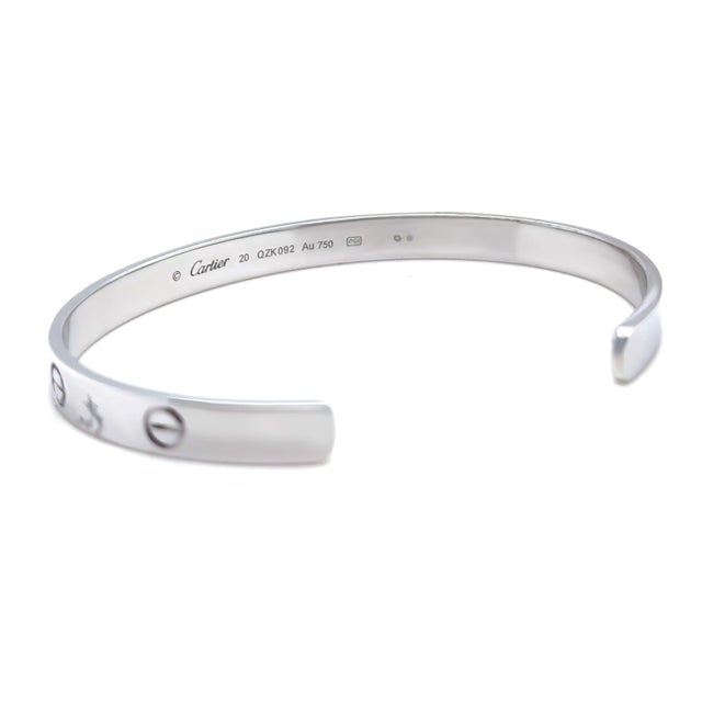 A timeless Cartier LOVE cuff bracelet crafted in 18ct white gold, featuring the Maison's iconic screw motif and open cuff...