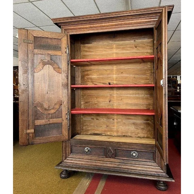 Louis XIII period cabinet in solid oak circa 1680 framed front opening with two molded and carved doors and a drawer...
