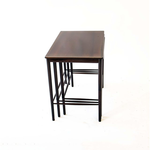This elegant set of three nesting tables embodies the minimalist design language of Scandinavian modernism at its finest....