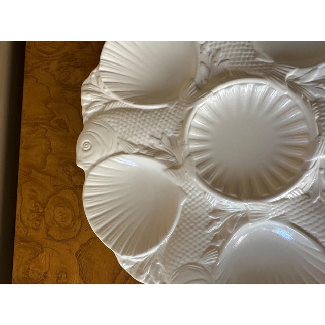 An exceptional antique oyster plate attributed to Mintons of Staffordshire, crafted in the traditional salt-glaze...