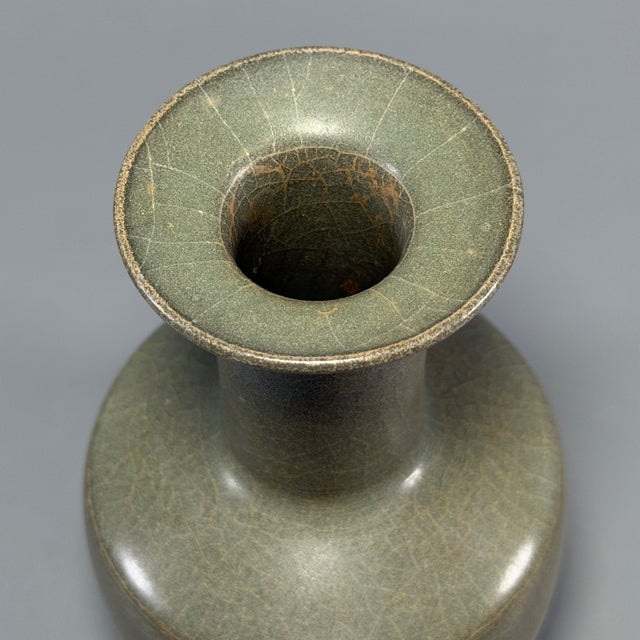Classic Chinese official‑style celadon disk‑mouth vase, with flat wide disk rim, tall straight neck and stout rounded...