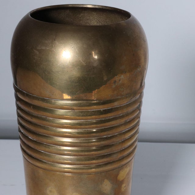 Modernist brass vessel with ridges. Made in India. Showing some signs of age and patina. Can be polished to shiny brass if...