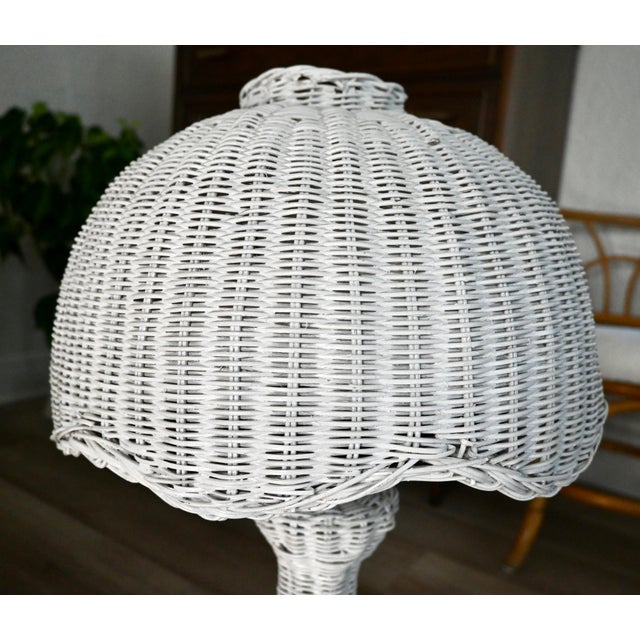 A sculptural vintage white wicker mushroom lamp with a clean, coastal feel and subtle postmodern influence. The woven...