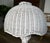 A sculptural vintage white wicker mushroom lamp with a clean, coastal feel and subtle postmodern influence. The woven...