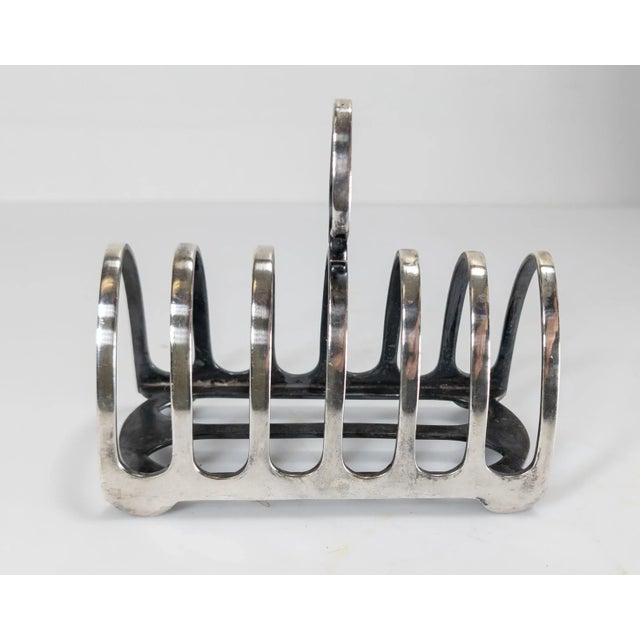 We are selling this nice Victorian Silverplate toast rack by Elkington & Co. Simple and elegant design, marked several...