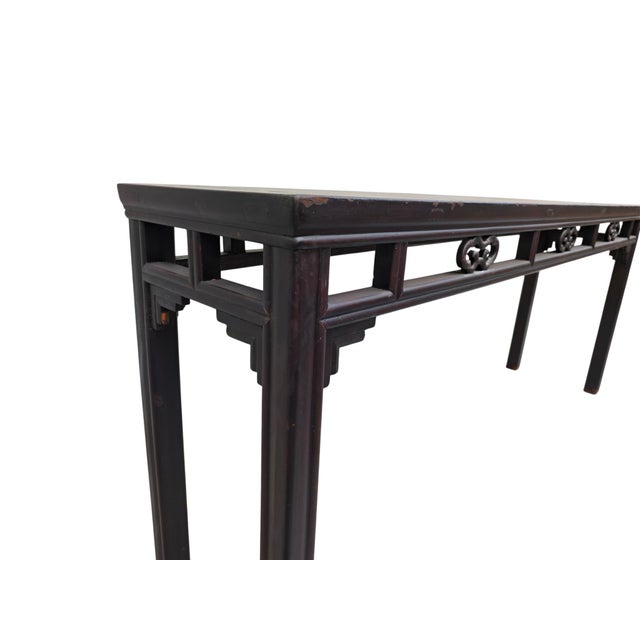 This 19th century console table is made from solid elm wood featuring a rich, dark brown lacquer finish. The long, narrow...