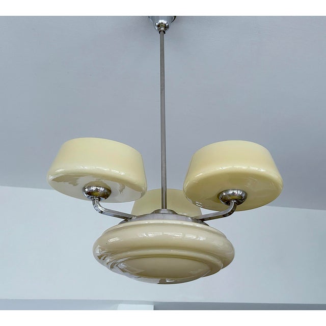 Art Deco pendant light featuring a nickel plated structure and ivory color glass shades Total Height 85 cm / 33.46 in...