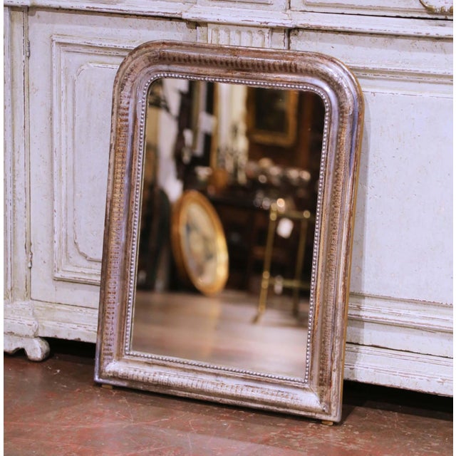 Crafted in France circa 1870, this elegant antique Louis Philippe wall mirror reflects the refined simplicity...