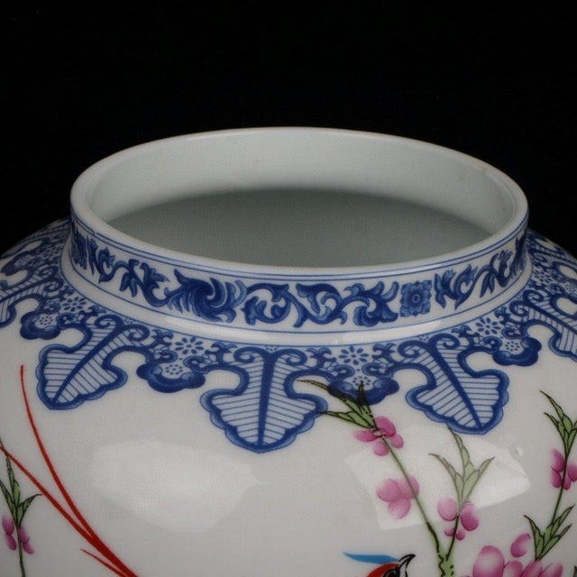 Elegant Chinese chinoiserie lidded general jar blending blue‑and‑white border ornamentation with vibrant famille‑style...