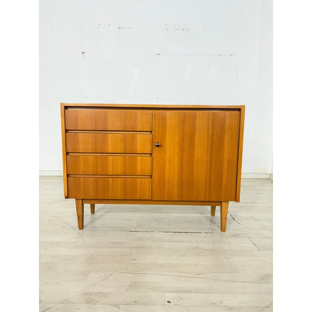 For sale is an exquisite elm chest of drawers, a prime example of timeless Scandinavian design and the aesthetics of Mid-...