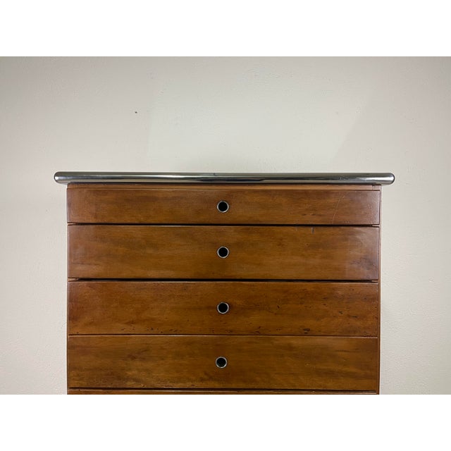 Wooden chest of drawers with eight drawers, steel details, and a smoked glass top in a Bauhaus style, made in Italy in the...