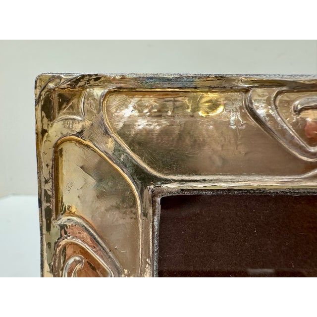 Small sterling silver picture frame with raised heart and scroll border design. Marked 925 with additional maker or...